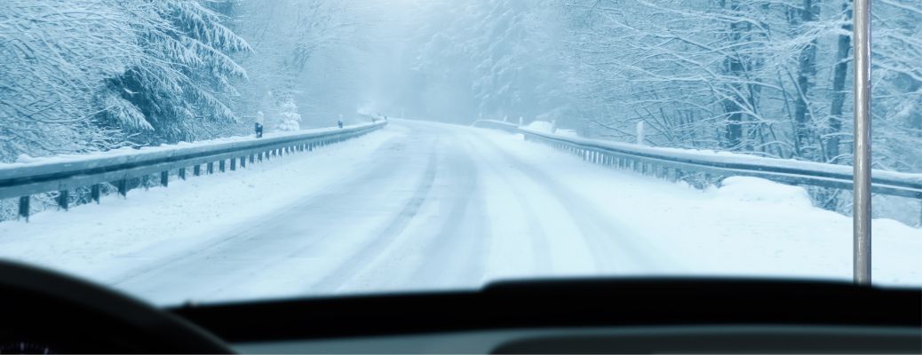 image of a snowy road from a car