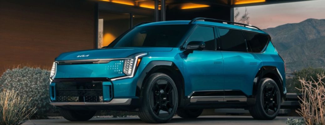 Kia EV9 parked near a building