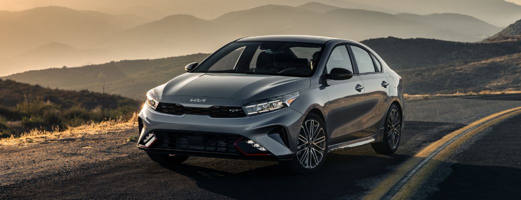2024 Kia Forte Green driving on the road