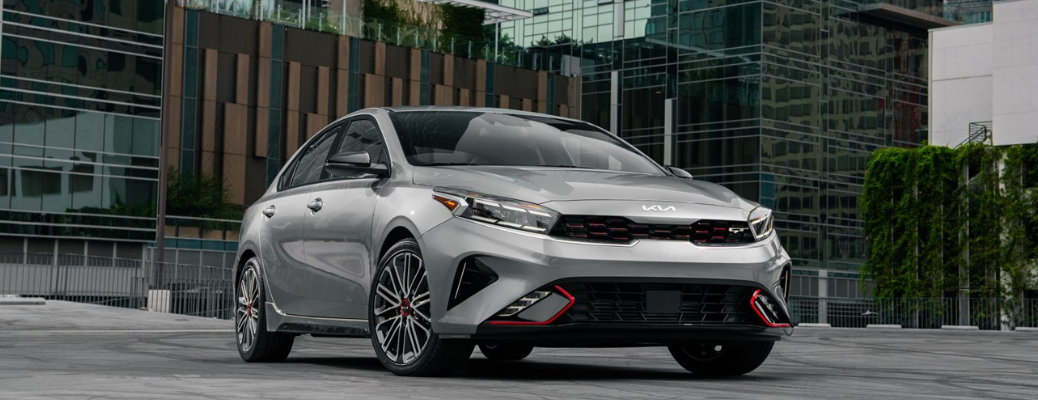 Front view of the 2024 Kia Forte parked in front of a building