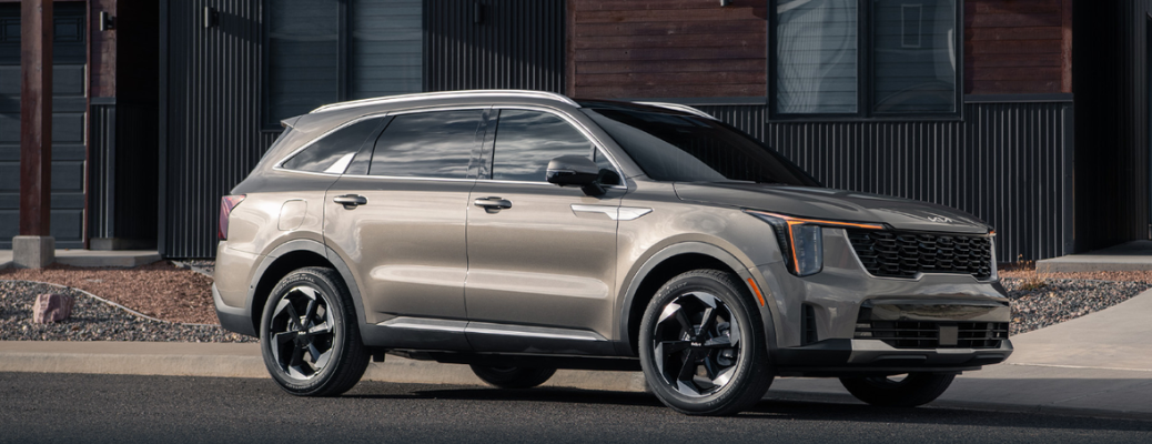 Side view of the 2025 Kia Sorento X-Pro parked in front of a building