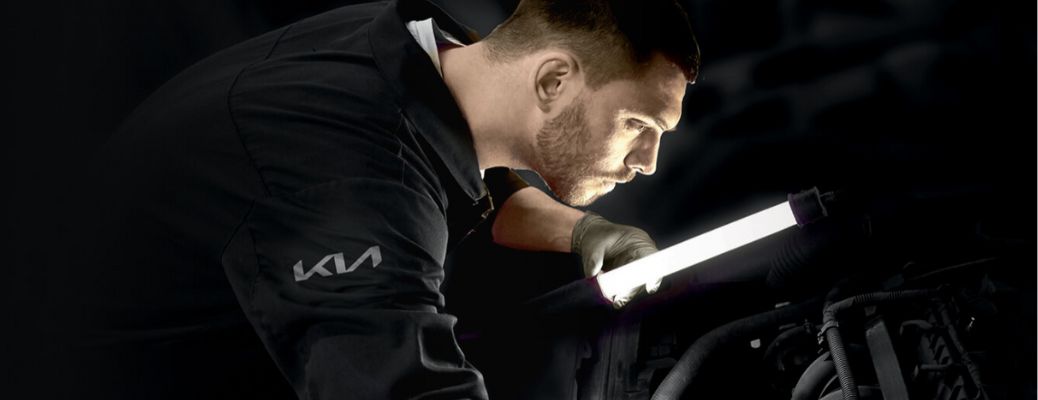 Kia technician working in dark