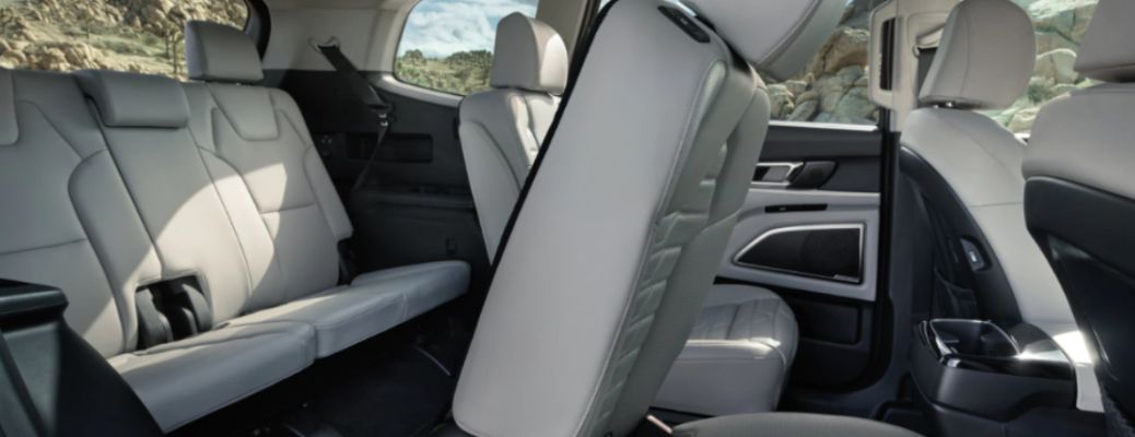 inside view of a Kia with 3 rows