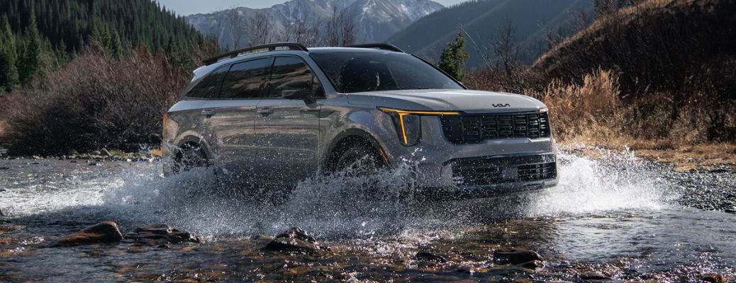 side view of the 2025 Kia Sorento off-roading in water