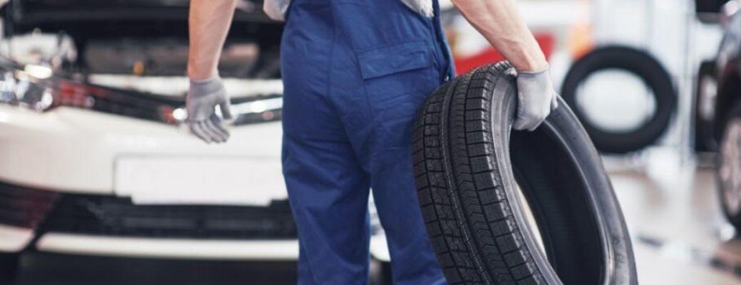 a technician holding a tire