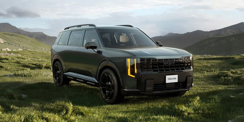 2027 Kia Telluride X-Pro off-road SUV driving on grass with all-terrain capability near Akron, OH